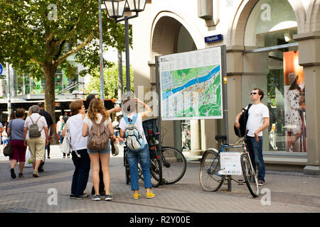 German people and foreigner travelers looking map of landmarks of heidelberger old town for tour at entrance market square on August 25, 2017 in Heide Stock Photo