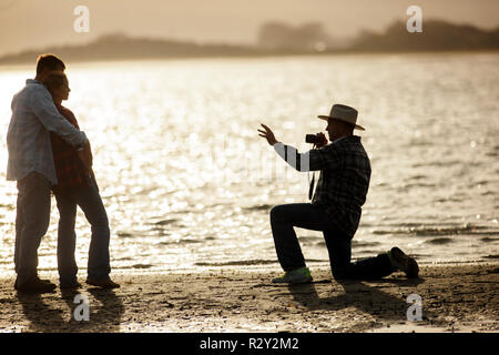 Young couple have a photography portrait session on the beach. Stock Photo