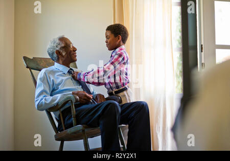 Smiling middle aged woman and her elderly father celebrating after working out a budget. Stock Photo