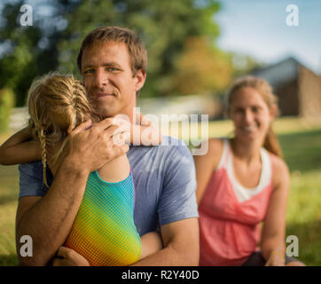 Portrait of a middle-aged father gently hugging his young daughter. Stock Photo