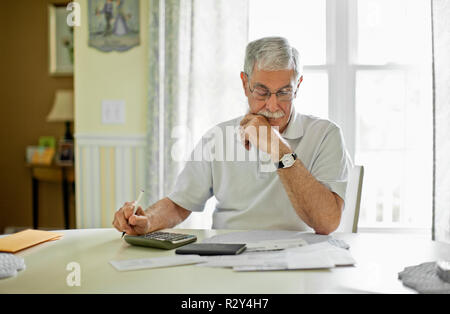 Stressed senior man calculating his home finances. Stock Photo