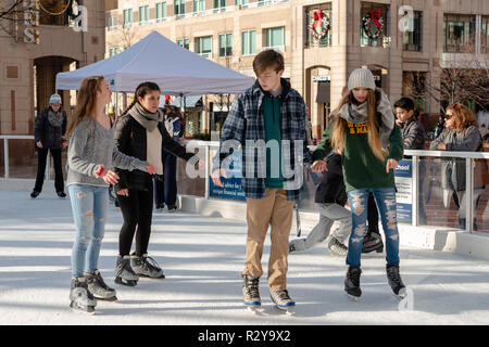 Reston VA -- November 17, 2018. Friends are ice skating together on the Reston Town Center rink. Stock Photo