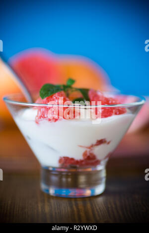 sweet homemade organic yogurt with slices of red grapefruit in a glass bowl Stock Photo