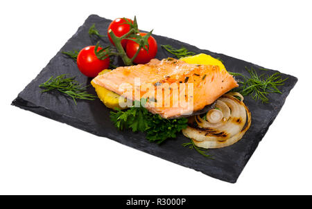 Slate with tender trout fillet, potatoes, cherry tomatoes and greens. Isolated over white background Stock Photo