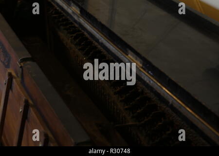 Inside old upright piano in hallway Stock Photo