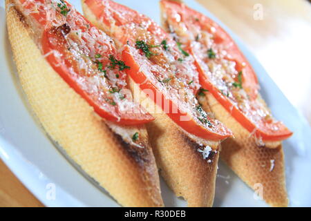 Sandwiches with tomatoes and melted cheese on top Stock Photo
