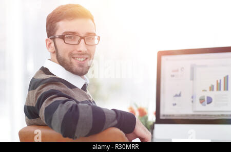 businessman analyzing financial graphs on computer Stock Photo