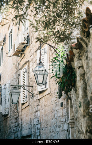 Street lights on the outside of a stone apartment building. Stock Photo