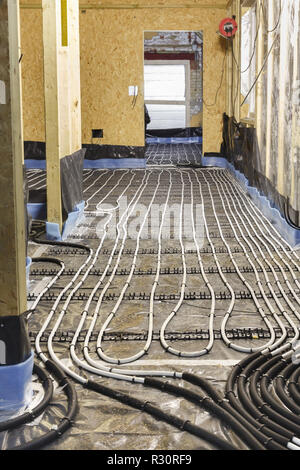 Underfloor heating water pipes installation to subfloor of a house under construction Stock Photo