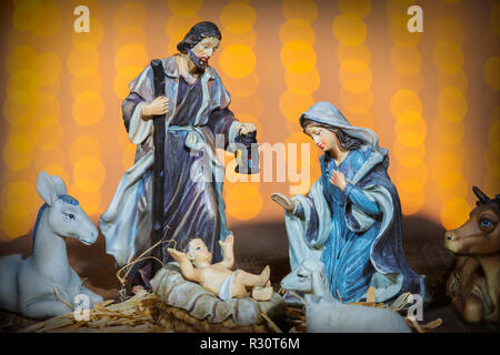 Christmas Manger scene with figurines including Jesus, Mary, Joseph and sheep Stock Photo