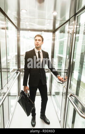 Man pressing elevator button. finger presses elevator button. businessman in lift Stock Photo