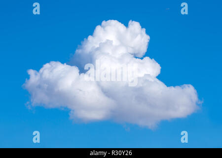 single lone cumulus cloud on blue sky Stock Photo