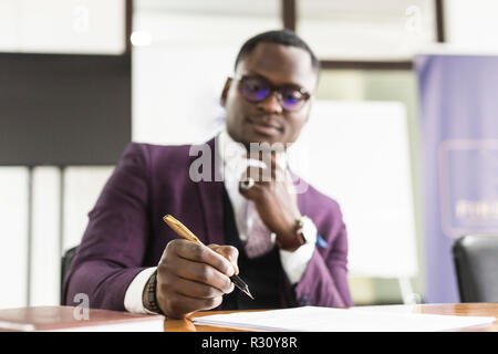 African american man signing contract, black man hand putting signature on official document, biracial clients customers couple make purchase or sign  Stock Photo