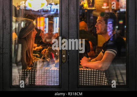 Prague, Czech Republic. 18th Nov, 2018. A couple enjoy a moment in a restaurant at the Old Town in Prague, capital of Czech Republic, Nov. 18, 2018. A historical city, the Czech capital is decorated with many medieval monuments. Along the Voltava River, the Old Town, the Lesser Town and the New Town were built between the 11th and 18th centuries. The Historic Centre of Prague was included in the UNESCO World Heritage List in 1992. Credit: Zheng Huansong/Xinhua/Alamy Live News Stock Photo