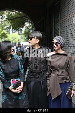 (181121) -- BEIJING, Nov. 21, 2018 (Xinhua) -- File photo taken on April 11, 2016 shows people wearing fashionable costumes outside the venue of a fashion show in east China's Shanghai. From 1978 when China started its reform and opening-up policy, a door to the outside world has been opened. Along with the imported commodities, fashion ideas inevitably slipped into China and since then the country, which was somewhat lack of fashion diversity, started its journey to pursue fashions. Over the past four decades, the thirst for beauty has driven Chinese people to pursue every possible fas Stock Photo