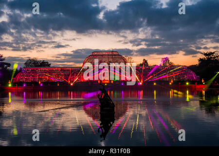 Kew Gardens, London, UK. 21st Nov 2018. Palm House Grand Finale with laser beams, streams of light and kaleidoscopic projections playing across a giant water screen, accompanied by Christmas music classics. - Kew at Christmas, Kew Gardens - Anl illuminated trail through Kew’s after-dark landscape, lit up by over one million twinkling lights. Ir Runs from 22 November 2018 – 5 January 2019. Credit: Guy Bell/Alamy Live News Stock Photo