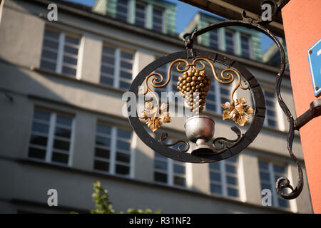 Forged bunch of grapes. Ornate wrought-iron elements of metal decoration at house in a city. Stock Photo