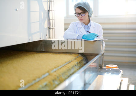 Young Woman Working at Factory Stock Photo