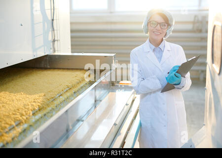 Female Factory Worker Posing in Sunlight Stock Photo