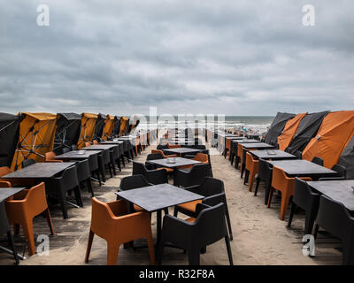 BELGIUM - DE PANNE SEAFRONT END OF SEASON - BELGIUM BEACH - EMPTY TABLES - AUTUMN SEASON IN THE BELGIUM SEAFRONT - COLOR STREET PHOTO © F.BEAUMONT Stock Photo