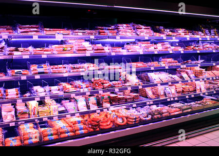 Shop of sausage and meat products. Wide choice of different sausages and meat products on shelves of shop. Sausages in shop Stock Photo