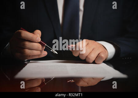 Notary working in office. Lawyer, attorney, business person signing a contract, working in office Stock Photo