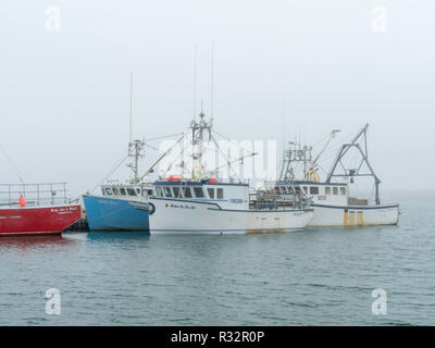 Lobster boats sit in a protected cove at Cape Forchu, Nova Scotia, Canada. Stock Photo