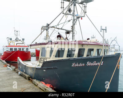 Lobster boats sit in a protected cove at Cape Forchu, Nova Scotia, Canada. Stock Photo