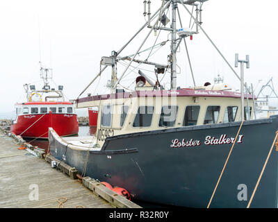 Lobster boats sit in a protected cove at Cape Forchu, Nova Scotia, Canada. Stock Photo