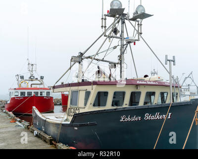 Lobster boats sit in a protected cove at Cape Forchu, Nova Scotia, Canada. Stock Photo