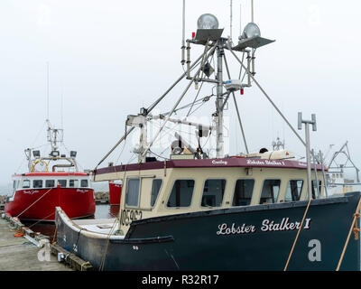 Lobster boats sit in a protected cove at Cape Forchu, Nova Scotia, Canada. Stock Photo