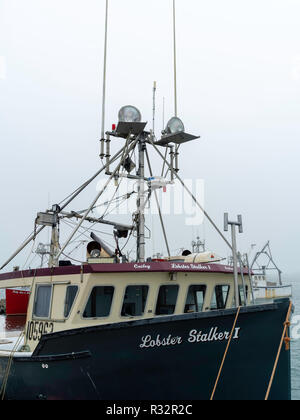 Lobster boats sit in a protected cove at Cape Forchu, Nova Scotia, Canada. Stock Photo