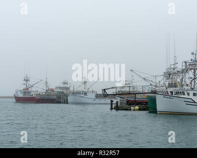 Lobster boats sit in a protected cove at Cape Forchu, Nova Scotia, Canada. Stock Photo