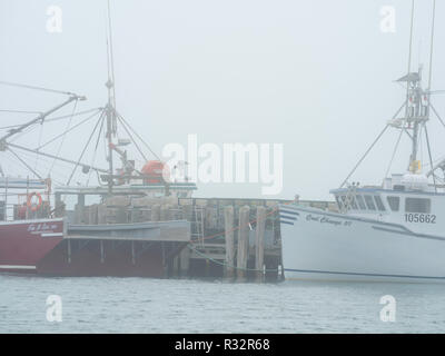 Lobster boats sit in a protected cove at Cape Forchu, Nova Scotia, Canada. Stock Photo