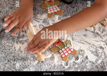 Making gingerbread men over wheat flour Stock Photo
