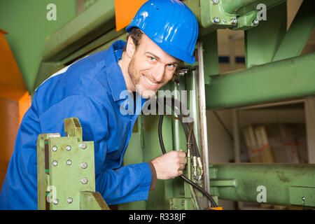 construction worker uses a machine Stock Photo