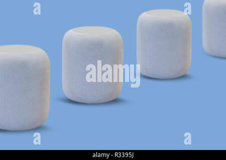 Wireless speakers for listening to music in a row on a blue background. Modern technologies. Stock Photo