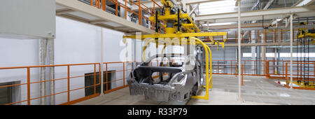 body of car on conveyor close-up. Automotive production line. long format. Wide frame Stock Photo