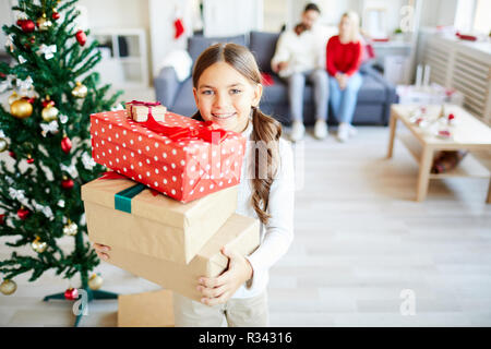 Girl with stack of giftboxes Stock Photo - Alamy