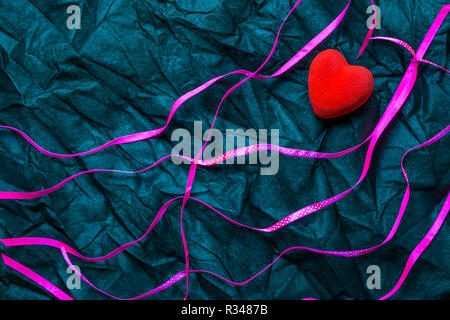 Red Heart And Purple Ribbons With White Polka Dot Pattern On Wrinkled Black Texture Background. Happy Valentine's Day And Love Concept. Romantic Card,