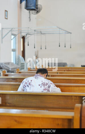 Batam, Indonesia. A man prays in the church. Stock Photo