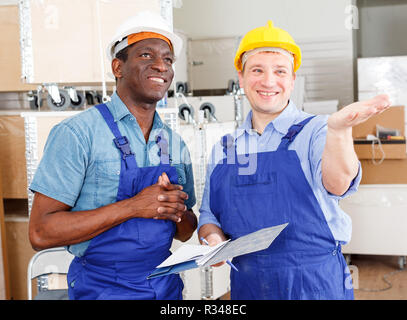 Professional male contractors discussing while determining scope of building work indoors Stock Photo
