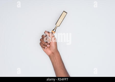 cropped shot of african american man holding chisel isolated on white Stock Photo