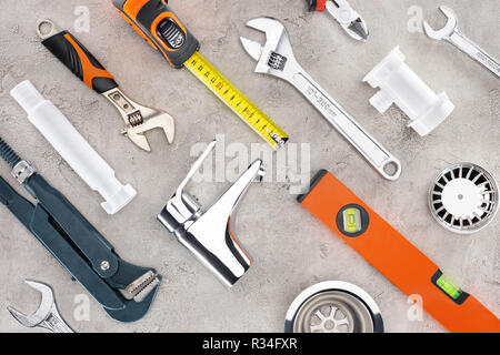 flat lay with various plumbing tools on concrete surface Stock Photo