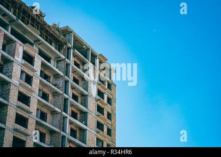 unfinished building with blue sky in the background in a sunny day. Developing of Construction industry Stock Photo