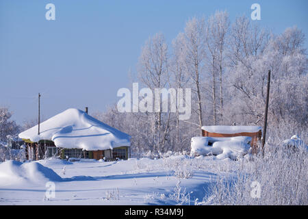 Traditional russian country house izba in village Talitsa under winter snow. Altai, Siberia, Russia Stock Photo