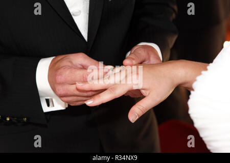 bride groom puts the ring on Stock Photo