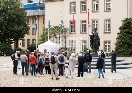 A group of tourists with a tour guide at the Statue of Grand Duchess Charlotte, Clairfontaine Square, Luxembourg city, Luxembourg, Europe Stock Photo