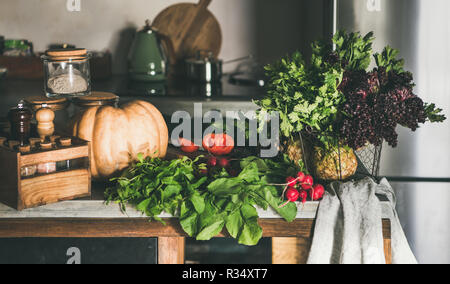 Variety of fresh vegetable ingredients on concrete kitchen counter Stock Photo