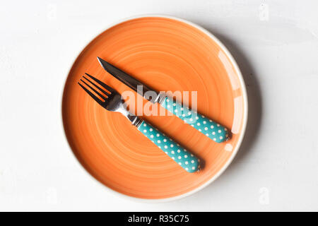 empty clean plate, fork and kinife Stock Photo